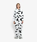 Full body view of a cozy cow kigurumi onesie for adults on a clean background.