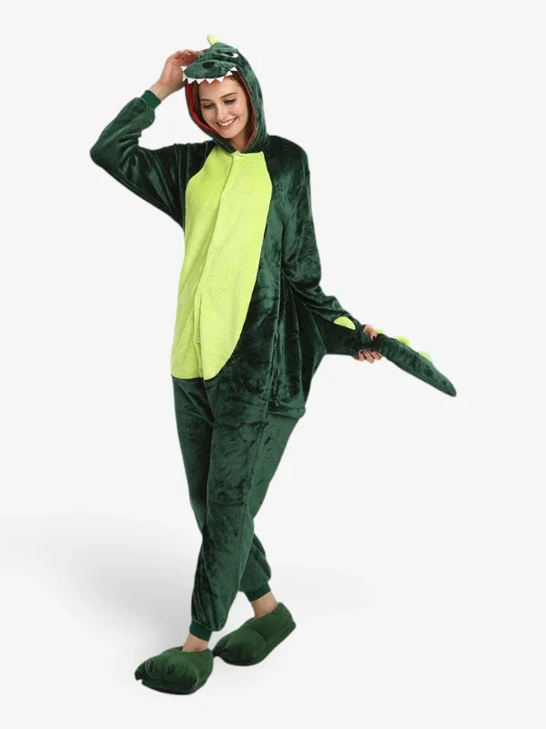 Woman smiling playfully and holding the tail while wearing the comfortable Dinosaur Onesie For Adults.