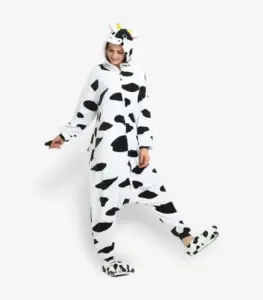 Woman modeling a comfortable adult cow onesie pajama costume.