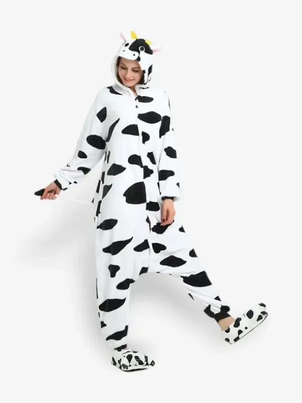 Woman modeling a comfortable adult cow onesie pajama costume.