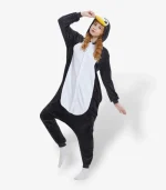 Person enjoying a playful moment wearing a warm, black and white Penguin Onesie For Adults.
