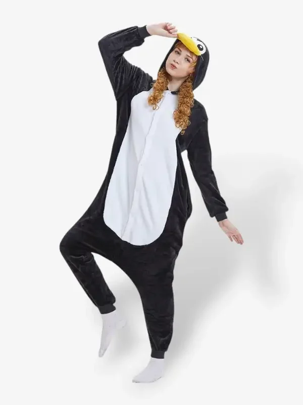 Person enjoying a playful moment wearing a warm, black and white Penguin Onesie For Adults.