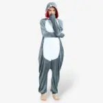 Woman smiling playfully with arms raised wearing the comfortable Shark Onesie For Adults.