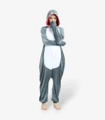 Woman smiling playfully with arms raised wearing the comfortable Shark Onesie For Adults.