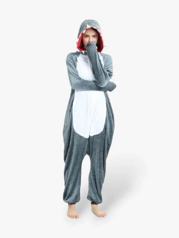 Woman smiling playfully with arms raised wearing the comfortable Shark Onesie For Adults.