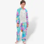 standing straight wearing a bright galaxy-patterned Unicorn Onesie for Kids against a light background.